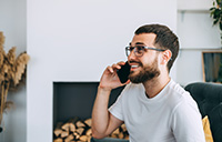 Person smiling on phone while calling local Monmouth County chimney service company